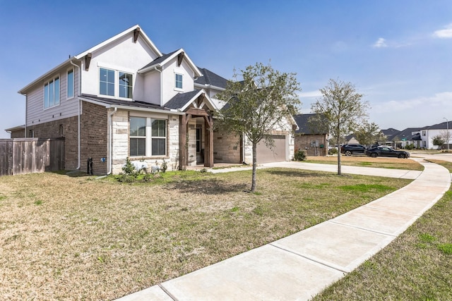 view of front facade with an attached garage, fence, concrete driveway, stone siding, and a front lawn