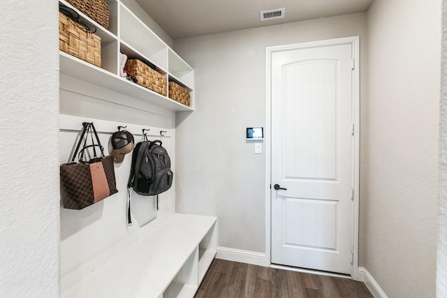 mudroom featuring dark wood-style floors, visible vents, and baseboards