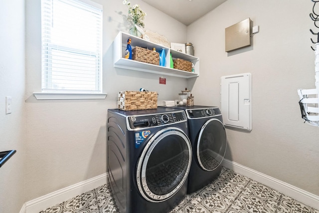 clothes washing area featuring laundry area, washer and clothes dryer, baseboards, and light tile patterned floors