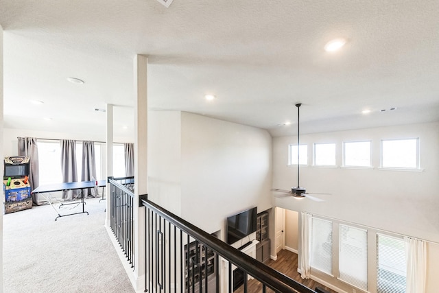 corridor featuring recessed lighting, carpet flooring, and an upstairs landing