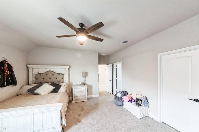 carpeted bedroom featuring baseboards, visible vents, vaulted ceiling, and a ceiling fan