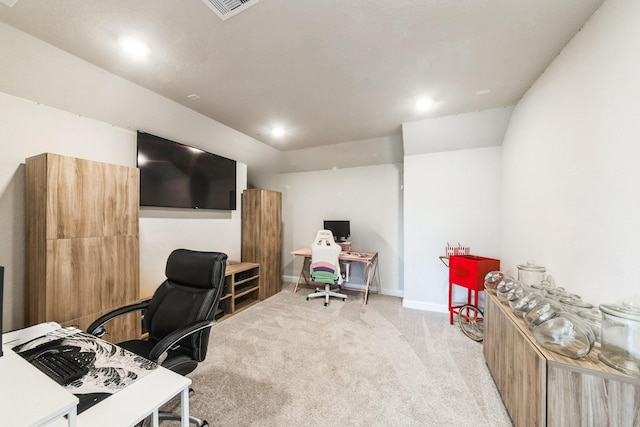 office area with baseboards, visible vents, and light colored carpet