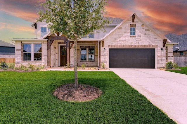 view of front of property featuring a garage, concrete driveway, stone siding, fence, and a front yard