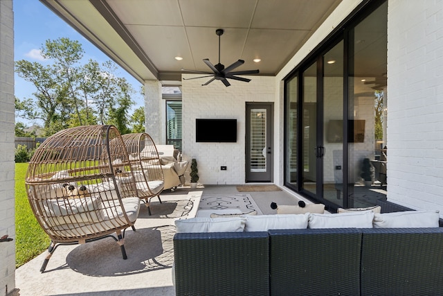 view of patio with an outdoor living space and a ceiling fan