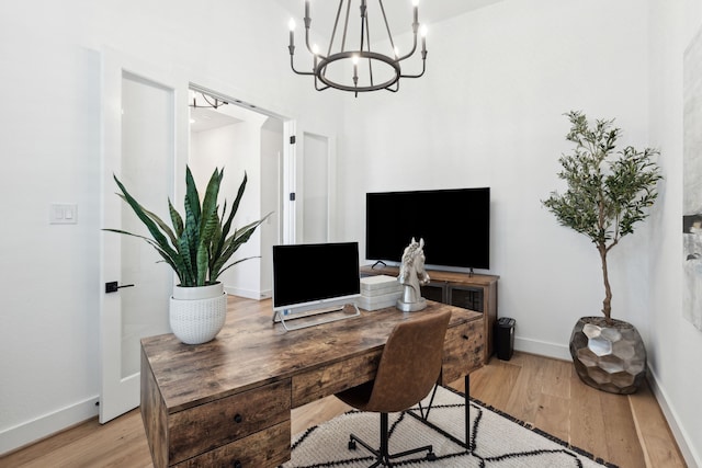 office with light wood-type flooring and baseboards