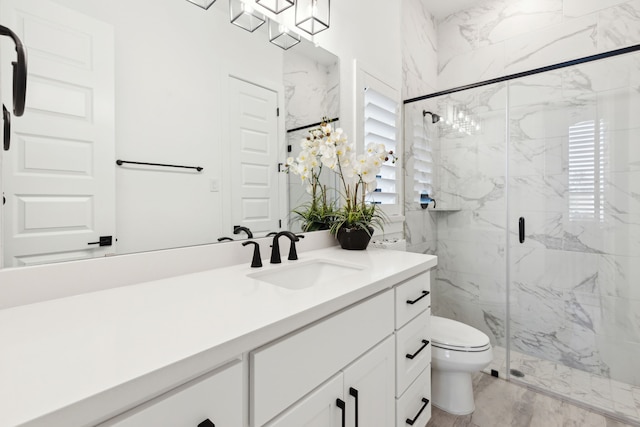 bathroom featuring vanity, plenty of natural light, a marble finish shower, and toilet