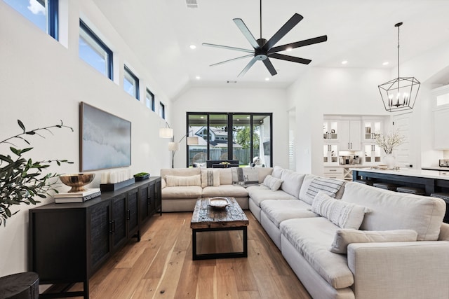 living area featuring light wood-type flooring, visible vents, high vaulted ceiling, and recessed lighting