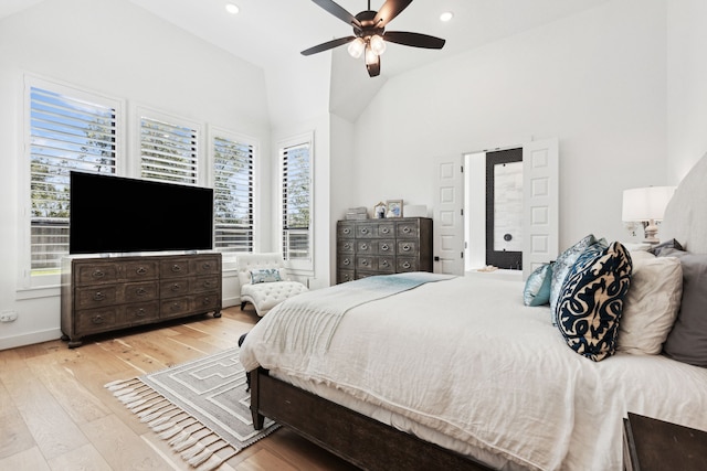 bedroom featuring vaulted ceiling, multiple windows, recessed lighting, and light wood-style floors