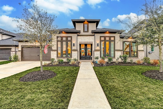 prairie-style house featuring a garage, concrete driveway, stone siding, french doors, and stucco siding