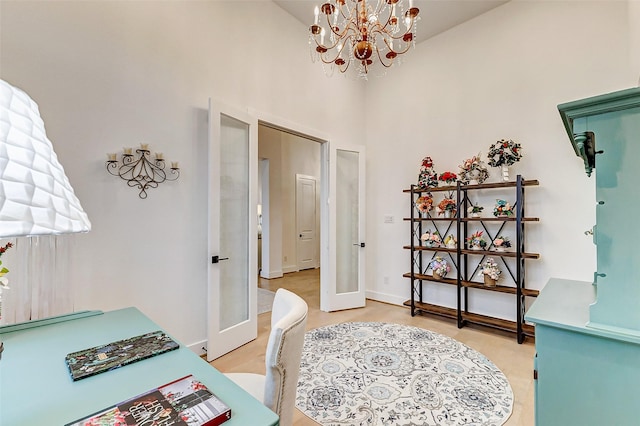 office area featuring baseboards, french doors, a high ceiling, and an inviting chandelier