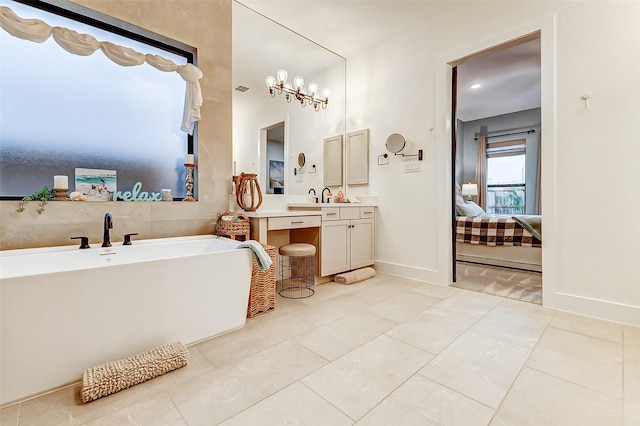 bathroom featuring ensuite bathroom, vanity, baseboards, a soaking tub, and tile patterned floors