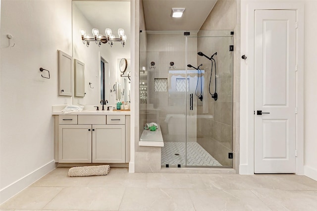 full bath featuring a stall shower, vanity, and baseboards