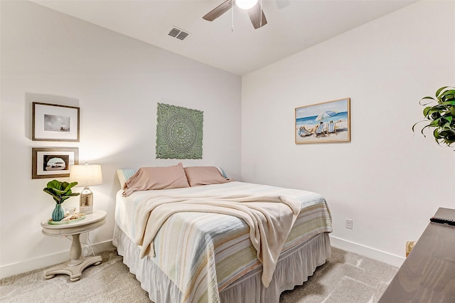 bedroom featuring light colored carpet, ceiling fan, visible vents, and baseboards