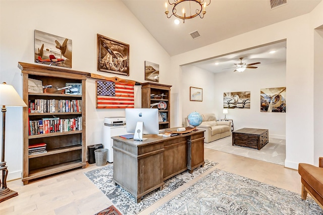 office space with lofted ceiling, ceiling fan with notable chandelier, visible vents, baseboards, and light wood-style floors