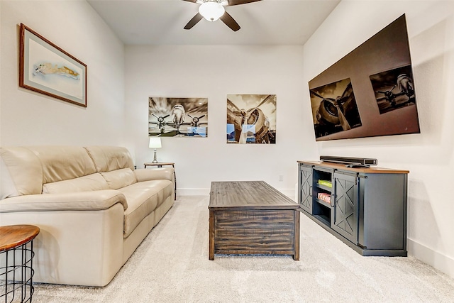 living area with carpet floors, ceiling fan, and baseboards