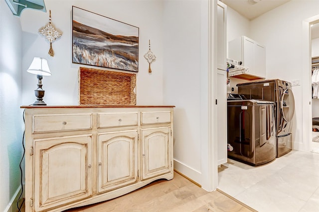 interior space featuring washing machine and dryer and baseboards