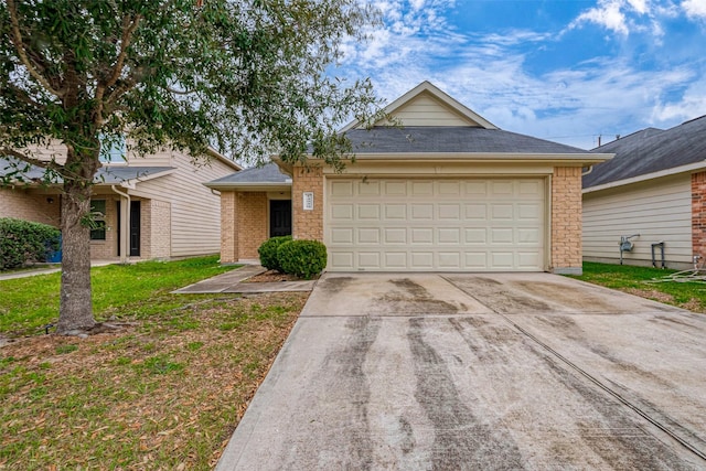 ranch-style house with concrete driveway, roof with shingles, an attached garage, a front yard, and brick siding