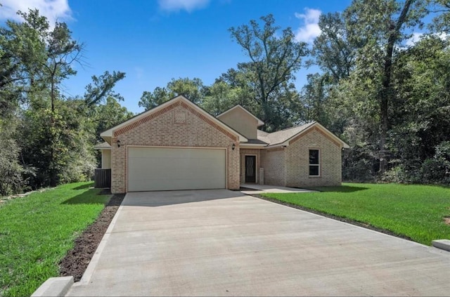 single story home featuring an attached garage, concrete driveway, brick siding, and a front yard