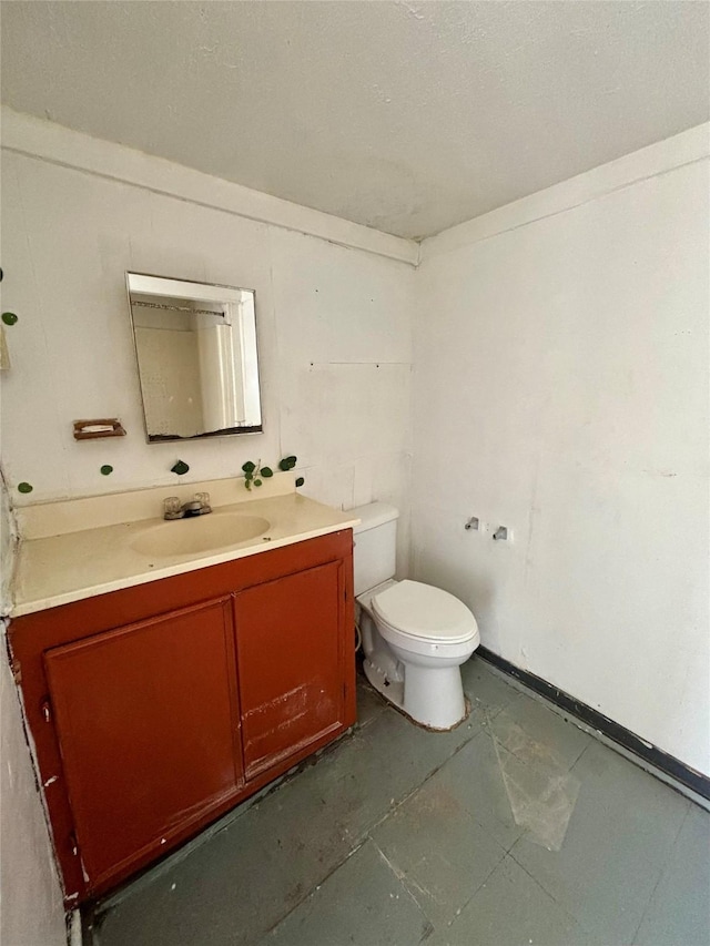 bathroom featuring toilet and vanity