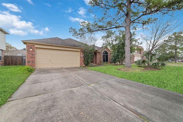 single story home featuring driveway, a garage, brick siding, fence, and a front yard