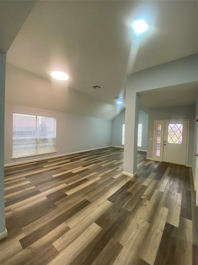 basement with dark wood-style floors, visible vents, and baseboards