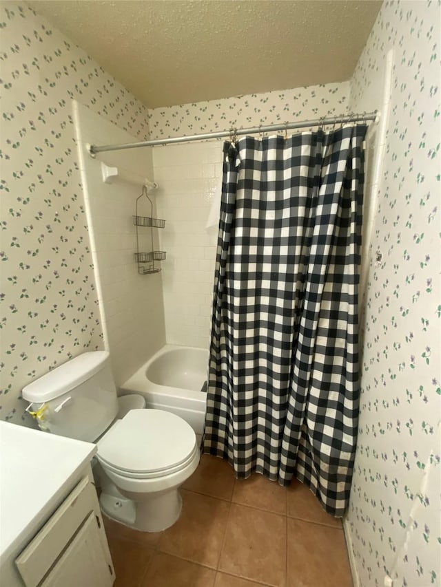 bathroom featuring a textured ceiling, tile patterned flooring, and wallpapered walls