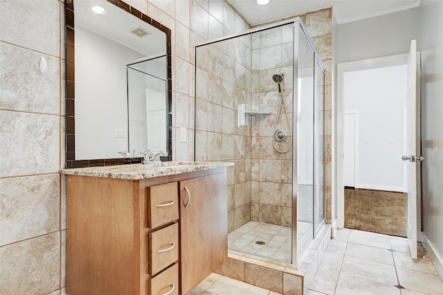 full bath featuring tile patterned flooring, a shower stall, and vanity