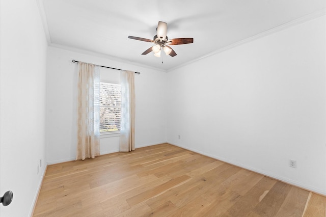 spare room with light wood-style floors, ornamental molding, baseboards, and ceiling fan