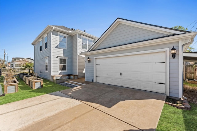 view of front of home with a front lawn, a vegetable garden, a detached garage, and an outdoor structure