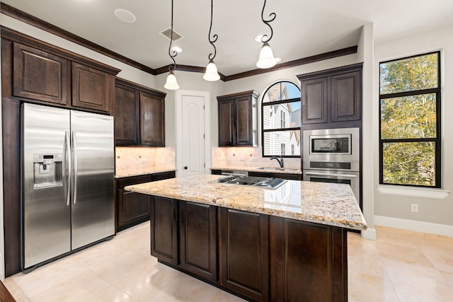 kitchen with visible vents, light stone countertops, stainless steel appliances, dark brown cabinets, and backsplash