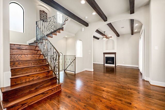 506 Knox St, Houston, TX 77007 - unfurnished living room with ceiling fan, arched walkways, dark wood-style flooring, beamed ceiling, and recessed lighting