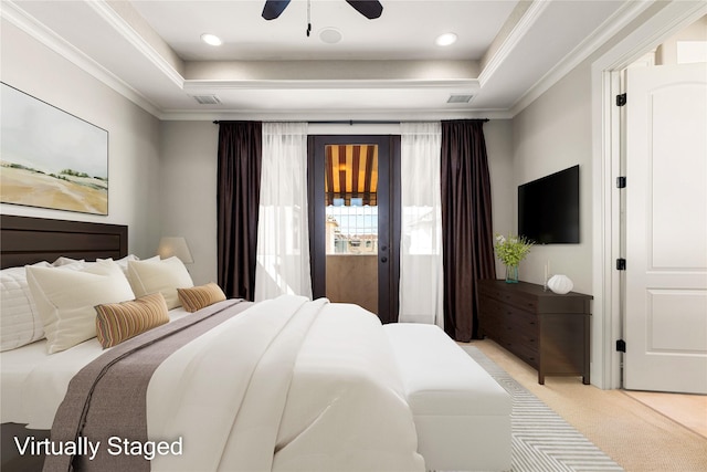 bedroom featuring visible vents, light colored carpet, access to outside, a tray ceiling, and crown molding