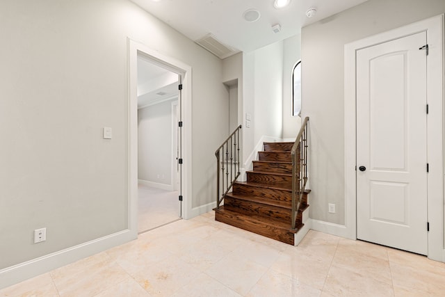 staircase with tile patterned flooring and baseboards