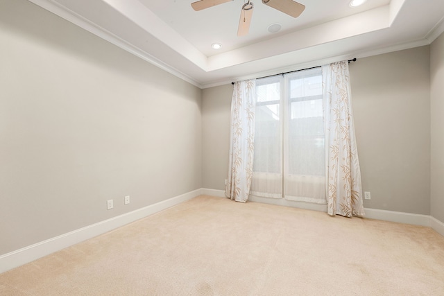 carpeted spare room with baseboards, a raised ceiling, a ceiling fan, and recessed lighting