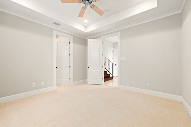 506 Knox St, Houston, TX 77007 - empty room with light carpet, a ceiling fan, a tray ceiling, ornamental molding, and recessed lighting