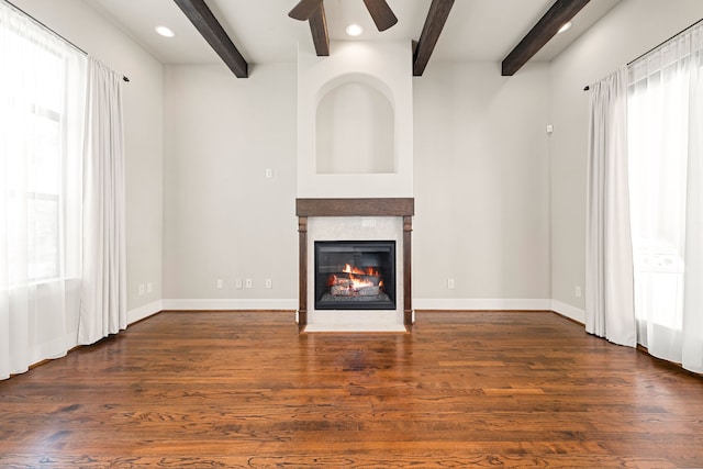 506 Knox St, Houston, TX 77007 - unfurnished living room featuring a glass covered fireplace, beamed ceiling, a ceiling fan, dark wood-style floors, and recessed lighting