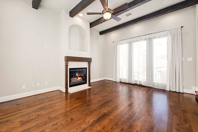 unfurnished living room with baseboards, a fireplace with flush hearth, visible vents, and wood finished floors