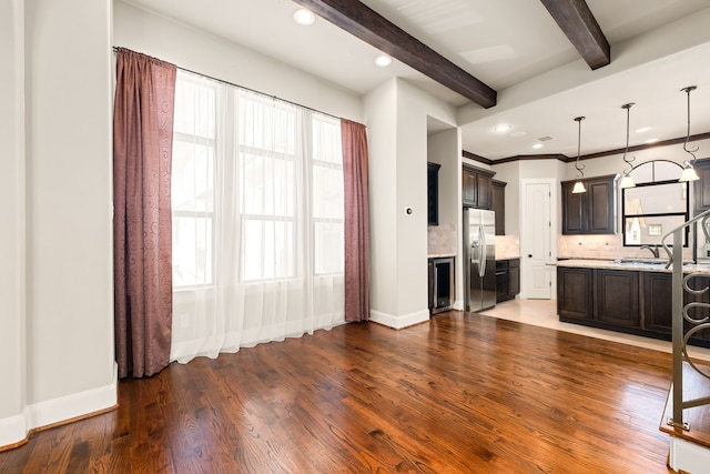 kitchen with wood finished floors, decorative backsplash, beam ceiling, and stainless steel fridge with ice dispenser