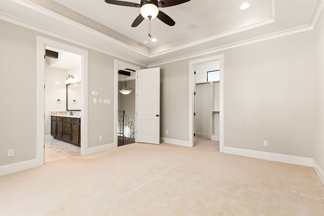 unfurnished bedroom featuring a tray ceiling, recessed lighting, ornamental molding, light carpet, and baseboards