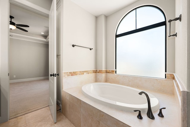 full bath featuring ornamental molding, tile patterned flooring, a garden tub, and a ceiling fan