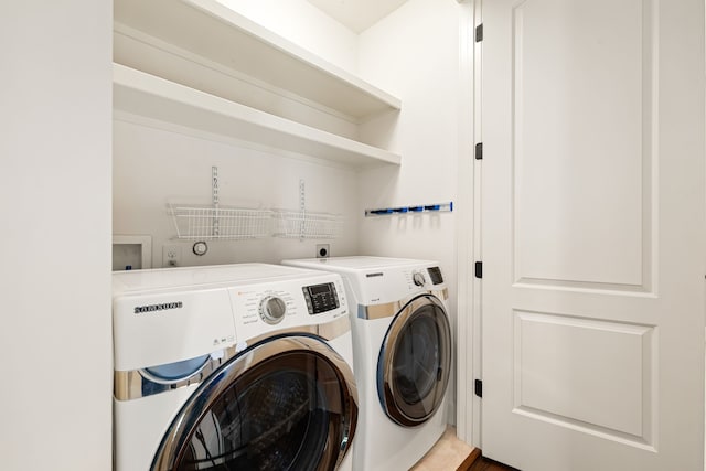 laundry area with laundry area and washing machine and clothes dryer