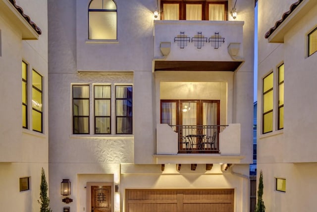 exterior space featuring a balcony and stucco siding