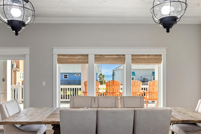 dining space with an inviting chandelier and crown molding