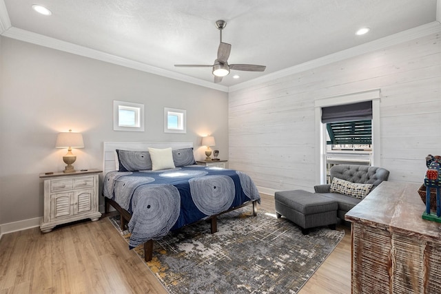 bedroom with a ceiling fan, wood finished floors, baseboards, wood walls, and crown molding