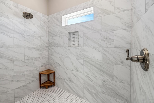 bathroom with a tile shower