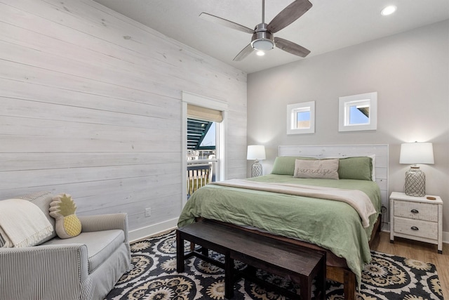 bedroom featuring a ceiling fan, wood finished floors, baseboards, recessed lighting, and access to exterior