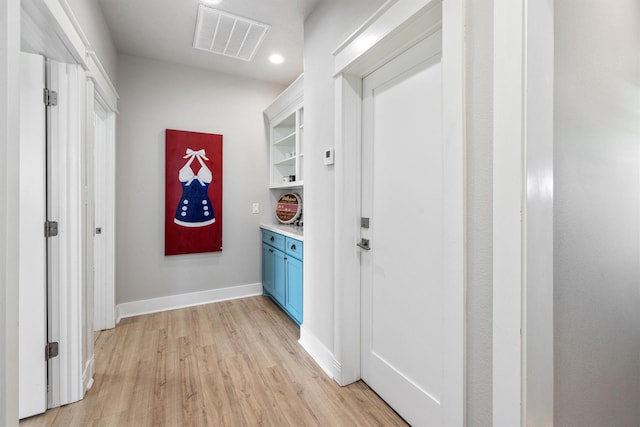 hall with recessed lighting, visible vents, baseboards, and light wood finished floors