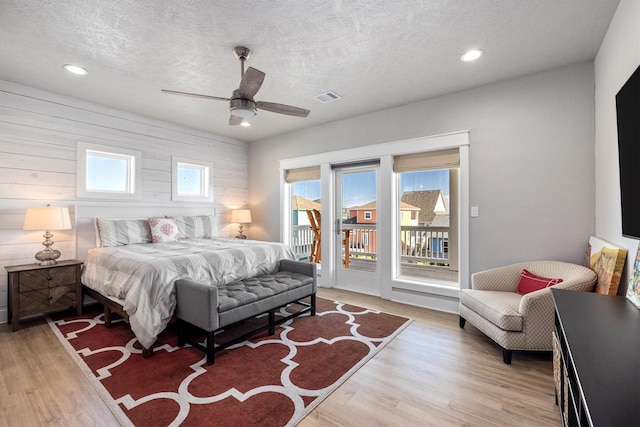 bedroom with visible vents, multiple windows, access to exterior, and light wood-style flooring