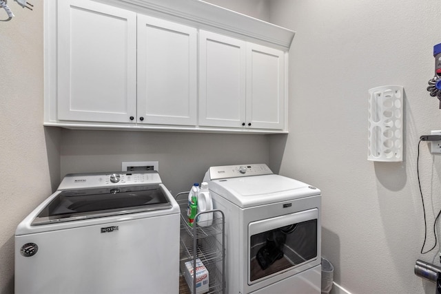 laundry area with washer and dryer and cabinet space