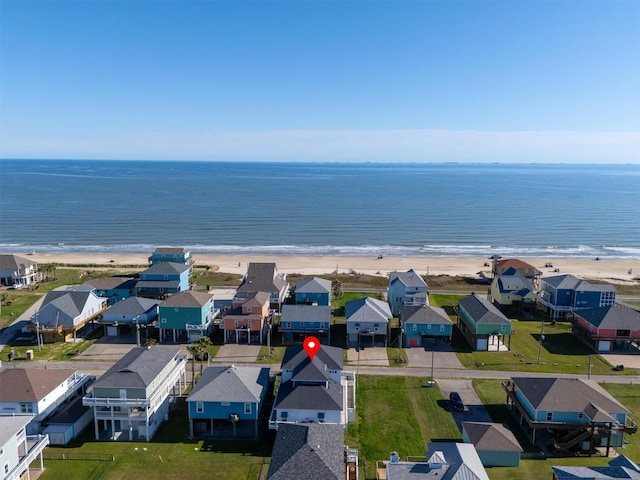 aerial view with a residential view, a water view, and a beach view